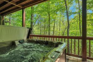 a hot tub on the deck of a house at 5br Waterfront Creek Home Hot Tub & Views in McCaysville
