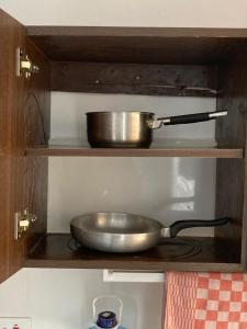 a metal pan on a shelf in a kitchen at Pamitos Sunny Paradise in Diani Beach in Diani Beach
