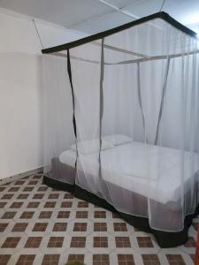 Ένα ή περισσότερα κρεβάτια σε δωμάτιο στο Gede Guest Homes