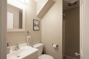 a bathroom with a sink and a toilet and a mirror at Northside Abode Close to Downtown in Missoula +19 photos