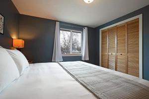 a bedroom with a large bed and a window at Northside Abode Close to Downtown in Missoula
