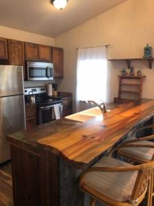 a kitchen with a wooden counter top and a refrigerator at Trail Street Condo Downstairs in Missoula