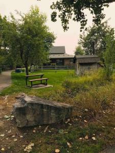a park with a bench and a tree and a building at Trail Street Condo Downstairs in Missoula +1 photo