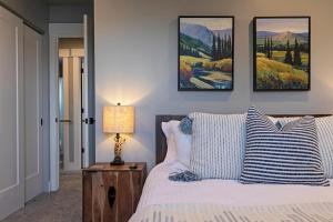 a bedroom with a bed with blue and white pillows at Modern abode in Central Missoula! in Missoula