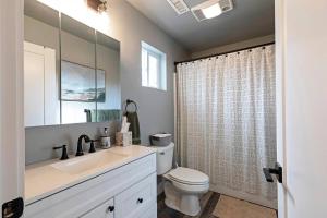 a white bathroom with a sink and a toilet at Modern abode in Central Missoula! in Missoula +24 photos