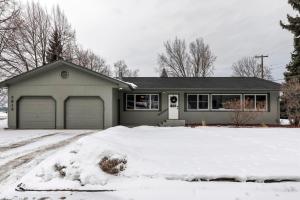 a house with a garage in the snow at Salish Court in Missoula