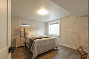 a bedroom with a bed and a brick wall at Salish Court in Missoula