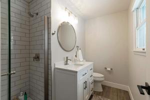 a white bathroom with a sink and a mirror at Salish Court in Missoula +17 photos