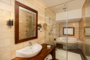 a bathroom with a sink and a shower and a tub at La Muraille, Galle Fort in Galle +29 photos