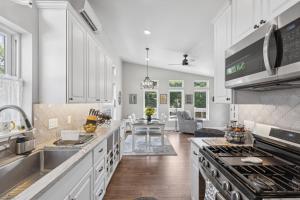 a kitchen with a sink and a stove top oven at Griz Country Cottage in Missoula