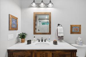 a bathroom with a sink and a mirror at Griz Country Cottage in Missoula +25 photos