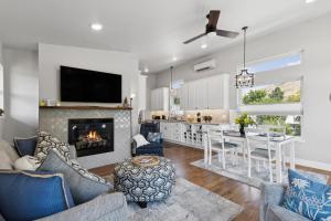 a kitchen and living room with a fireplace and a table at Griz Country Cottage in Missoula