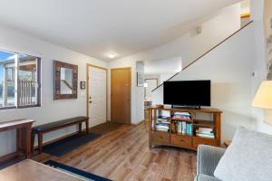 a living room with a couch and a tv at Close to downtown on Riverfront Park in Missoula