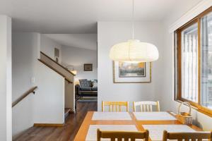 a dining room and living room with a table and chairs at Close to downtown on Riverfront Park in Missoula