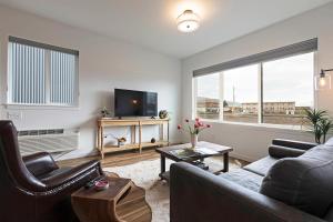 a living room with a couch and a tv at The Railway Flats 102 in Missoula