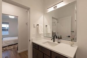 a bathroom with a sink and a large mirror at The Railway Flats 102 in Missoula +30 photos