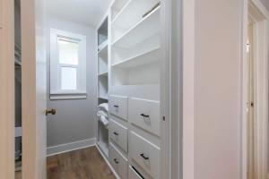 a walk in closet with white cabinets and a window at Slant Streets Bungalow in Missoula +16 photos