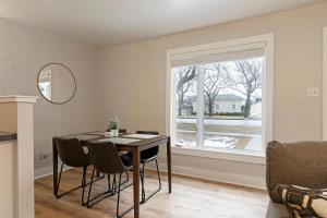 a dining room with a table and chairs and a window at Slant Streets Bungalow in Missoula