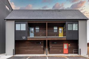 a building with a red door and a balcony at The Railway Lofts 201 in Missoula