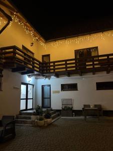 a large room with stairs and lights on the wall at Готель White House in Yablunytsya