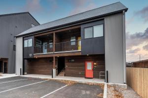 a building with a red door in a parking lot at The Railway Flats 101 in Missoula
