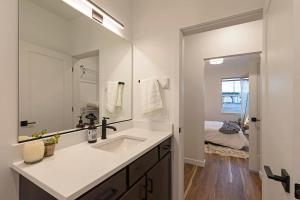 a bathroom with a sink and a large mirror at The Railway Flats 101 in Missoula +51 photos