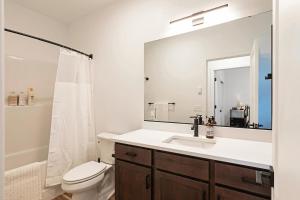 a bathroom with a sink and a toilet and a mirror at The Railway Lofts 202 in Missoula +22 photos