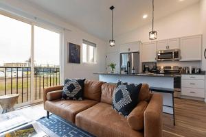 a living room with a couch and a kitchen at The Railway Lofts 202 in Missoula