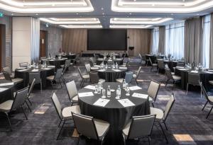 a conference room with tables and chairs and a projection screen at Best Western Premier Westlands in Nairobi