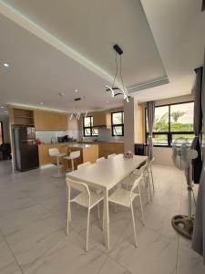a kitchen with a white table and chairs in a room at ICB Suites in Tagbilaran City