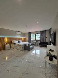 a large living room with a bed and a couch at ICB Suites in Tagbilaran City