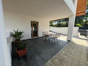 a patio with a table and chairs in a house at Holiday Home Počúvadlo in Počúvadlo