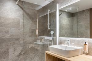a bathroom with a sink and a mirror at Mercure Ax Les Thermes in Ax-les-Thermes +41 photos