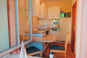 a small kitchen with a wooden table and chairs at Residenz-Seestern-Whg-31 in Kühlungsborn +24 photos
