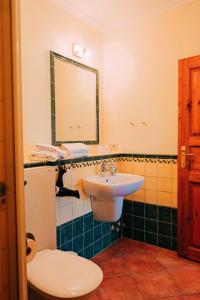 a bathroom with a sink and a toilet and a mirror at Residenz-Seestern-Whg-31 in Kühlungsborn +26 photos