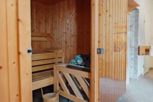 a room with a sauna with a wooden wall at Residenz-Seestern-Whg-31 in Kühlungsborn