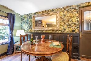 a dining room with a table and a mirror at The Stables in Hambleton