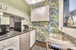 a kitchen with white cabinets and a sink at The Stables in Hambleton +13 photos