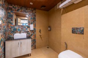 a bathroom with a sink and a toilet at goSTOPS Mussoorie Clock Tower in Mussoorie +66 photos