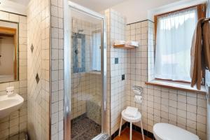 a bathroom with a shower and a toilet and a sink at Agritur Agua Biencia in Pera +27 photos