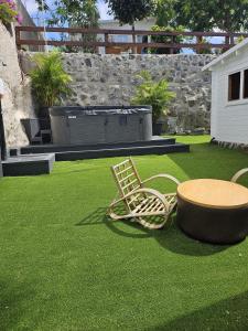 a patio with a table and chairs on a lawn at Calao in Tijoco de Abajo
