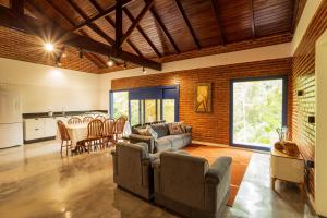 a living room with a couch and chairs and a table at Sitio Dona Bela - Rio da Prata in Joinville