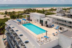 an aerial view of a resort with a swimming pool and the beach at Miami Ocean Drive 1BR APT & Rooftop Pool Access in Miami Beach