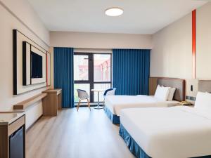 Ένα ή περισσότερα κρεβάτια σε δωμάτιο στο Holiday Inn Express Shanghai Putuo by IHG