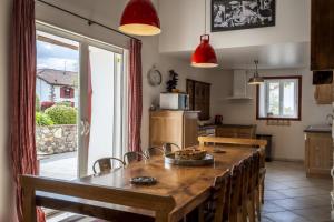 a kitchen with a large wooden table with chairs at Martirenia in Ossès