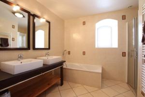 a bathroom with two sinks and a bath tub at Martirenia in Ossès +48 photos