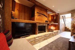 a living room with a large television and a fireplace at Martirenia in Ossès