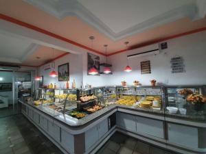 a buffet line with many different types of food at HOTEL POUSADA ALAGOINHAS in Alagoinhas +26 photos