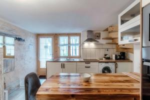 a kitchen with a wooden table and a sink at Casa Edera by Quokka 360 - Romantic Wooden House in Solduno