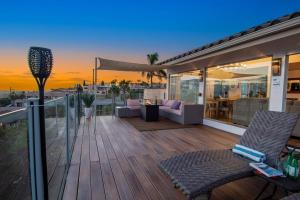 a deck with two chairs and a table on a house at Luxury Hilltop Retreat in the City - Amazing View in San Diego